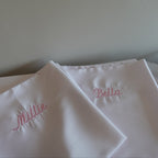 satin white pillowcases with embroidered names in pink thread